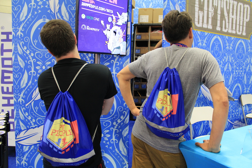 Co-founders of Behemoth (left to right), Dan Paladin & John Baez, model the Pit People bags (PAX West drawstring bags style may vary)