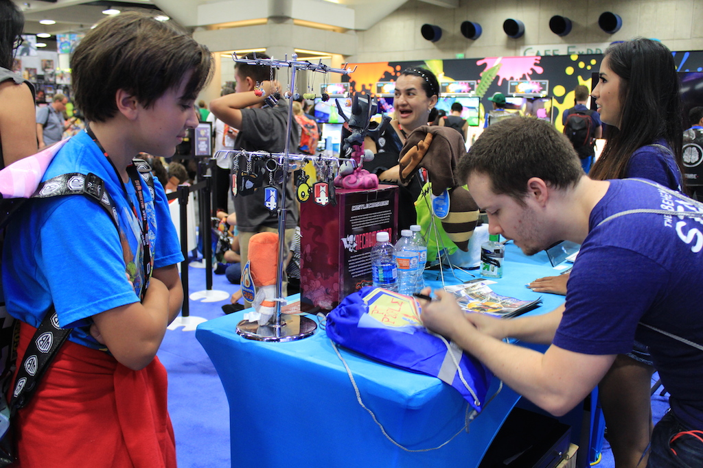 Dan autographing a fan's Pit People bag